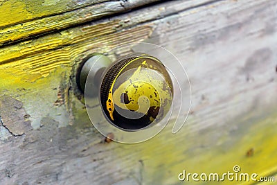 Round brass handle on a wooden door Stock Photo