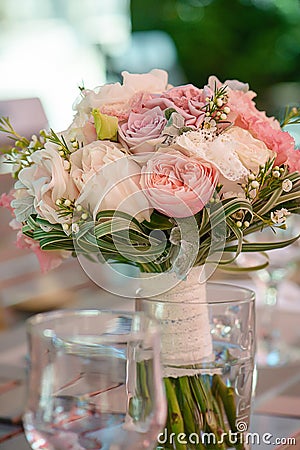 Round bridal bouquet featuring pastel color peonies and roses, lace and greenery, set on a table, with selective focus Stock Photo