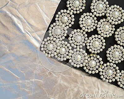 Round brooch with pearls on a black and silver background Stock Photo