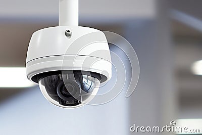 A round CCTV camera attached to ceiling. Camera monitoring inside the light empty room building. Digital security eye. Image is AI Stock Photo