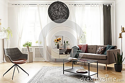 Round chandelier in a retro living room interior Stock Photo