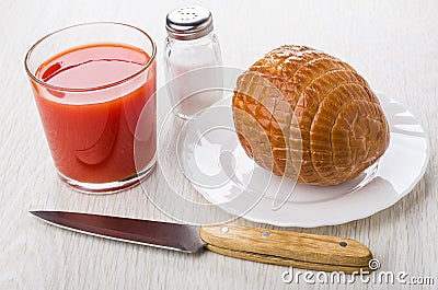 Round chicken smoked sausage, salt, glass of tomato juice, knife Stock Photo