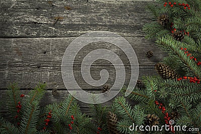 Round Christmas Holiday Evergreen Pine Branches and Red Berries Over Wood Background. Christmas wreath background baner. Circular Stock Photo