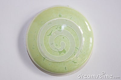 Round clay sample covered with soft green glossy glaze Stock Photo