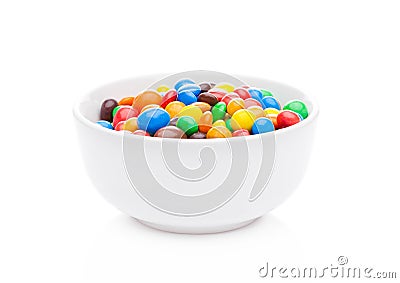 Round colorful coated sweet candies in white bowl Stock Photo