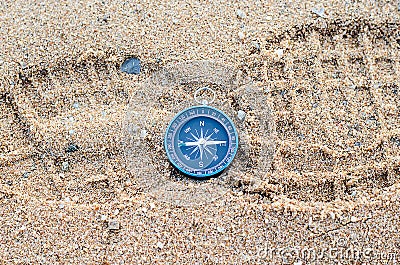 Round compass on sand footmark Stock Photo