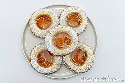 Round cookies with fruit jam and icing sugar, italian occhi di bue, isolated on white Stock Photo