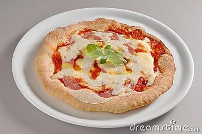 Round dish with classic pizza of Naples Stock Photo