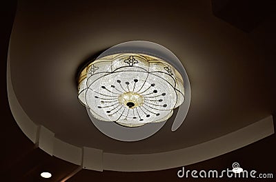 Round drop ceiling with lamps / lighting fixtures. Modern interior photo. Abstract architecture in shades of light gray / white co Stock Photo