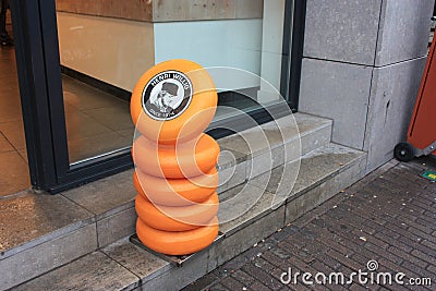 Round Dutch cheese shapes stacked in a row outside a Dutch shop Editorial Stock Photo
