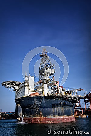 Round FPSO berthing at port with blue sky Stock Photo