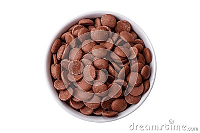 Round granules of sweet confectionery chocolate as an ingredient for preparing desserts Stock Photo