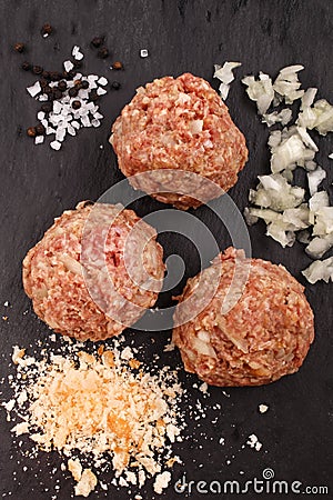 Round meat balls with chopped onion, salt, peppercorns and bread Stock Photo