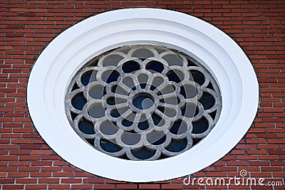 Round Mosaic Window in the Brick Wall Stock Photo