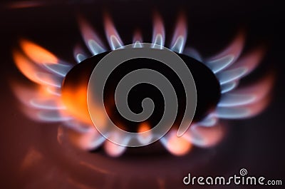 Round orange blue burning gas flame black background close up Stock Photo