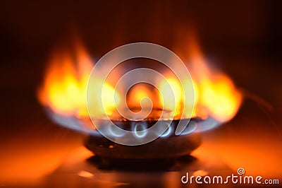 Round orange blue burning gas flame black background close up Stock Photo