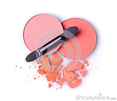 Round orange crashed eyeshadow and blusher for makeup as sample of cosmetics product with applicator Stock Photo