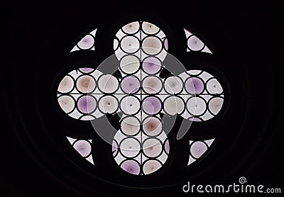 Round purple stained glass window with cross Stock Photo