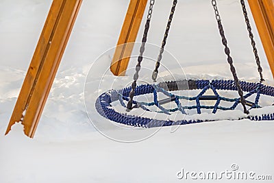 Round rope swing drowned in snow Stock Photo