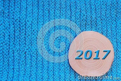 Round saw cut alder and blue date 2017 on blue knitted fabric b Stock Photo