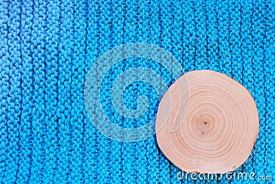 Round saw cut alder on blue knitted fabric background. Stock Photo