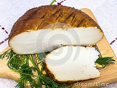 Round soft brown smoked homemade cheese Stock Photo