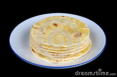 Round soft corn mini tortillas pancakes on plate isolated black macro Stock Photo