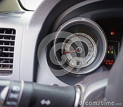 A round speedometer is in a machine, ran back Stock Photo