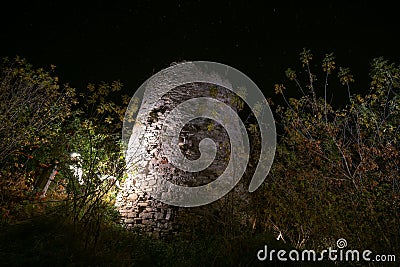 Round tower. Ruins of the old castle in the city of Sataniv. Remains of the fortress, autumn night. Stars in the sky. Ukraine Editorial Stock Photo