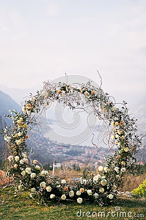 Round wedding arch stands on a mountain overlooking the sea valley Stock Photo