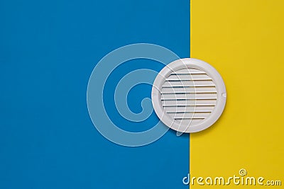 Round white ventilation grate on a two-color background. Stock Photo