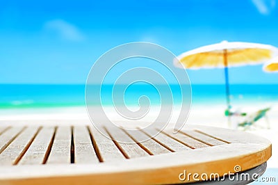 Round wood table top on blur beach background Stock Photo