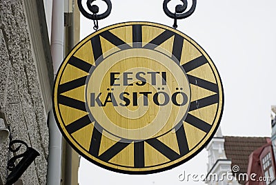 Round wooden sign of an estonian handicraft shop in Tallinn Editorial Stock Photo