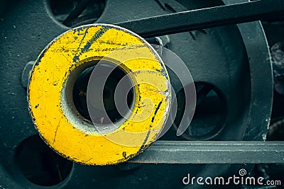 Round yellow motoblock pulley with drive belts close-up. Background from an industrial object. Agricultural machinery Stock Photo