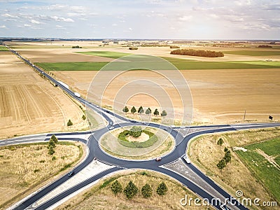 Roundabout drone aerial view with vehicles circling around the traffic circle lane, France country side rural road transportation Stock Photo