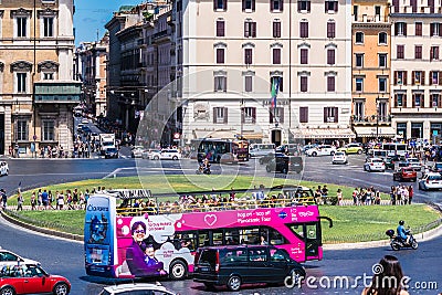 Roundabout at Piazza Venezia in Rome. Traffic junction in front of the monument Vittorio Emanuele II. Colourful hop-on hop-off bus Editorial Stock Photo