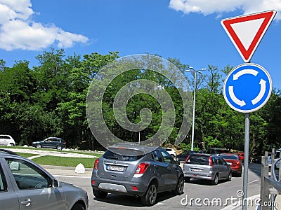 Roundabout traffic, road signs and cars on road Editorial Stock Photo
