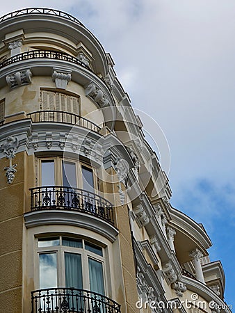 Rounded corner of classy baroque house downtown in Madrid, Spain. Elegant vintage Spanish classical architecture Stock Photo