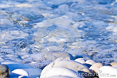 Rounded white stones under fresh transparent water Stock Photo