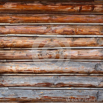 Roundish Rustic Log Wall Horizontal Timber Background. Natural texture part facade of a log wall of cabin or house Stock Photo