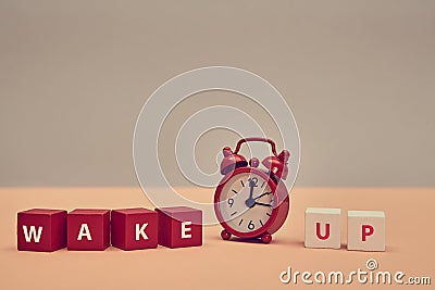 Rouse from sleep. Stop sleeping. Start new day. Awakening. Wake up inscription on wooden cubes. Alarm clock. Copy space Stock Photo