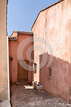 Roussillon ochre coloured alley village house buildings in France Stock Photo