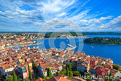 Rovinj city skyline overlooking the orange rooftops of old houses, the picturesque harbor Stock Photo