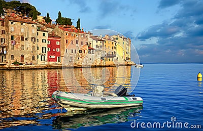 Rovinj, Croatia. Boat in harbor during sunrise in town Rovigno Stock Photo