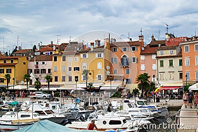 Rovinj, Croatia; 7/18/2019: Facades of the typical croatian colorful houses in the port of Rovinj, Croatia, with a lot of boats at Editorial Stock Photo