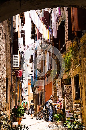 Rovinj, Croatia-June 25, 2017: Narrow Street With Hanging Clothes. Editorial Stock Photo