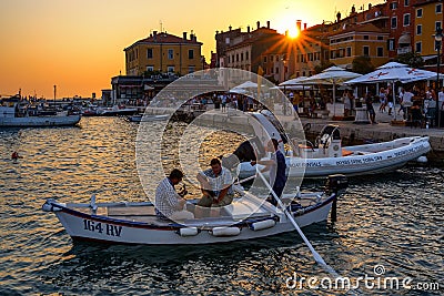 Traditional Batana boat parade at sunset in Rovinj, Croatia Editorial Stock Photo