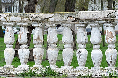 Row of ancient stone railings in city park close up. Ruined long of period. Stock Photo