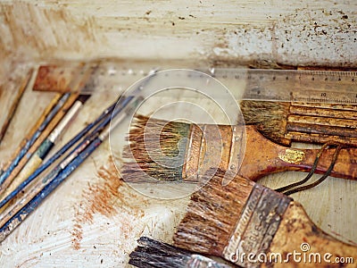 Row of artist paintbrushes closeup on artistic background Stock Photo