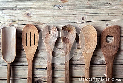 Row of assorted old wooden kitchen utensils Stock Photo